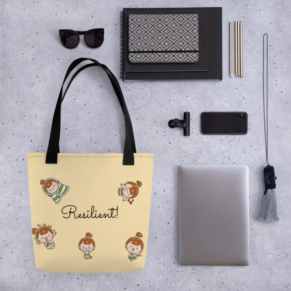 pictures of yellow tote bag with cute girl on it and the world "resilience" written in script